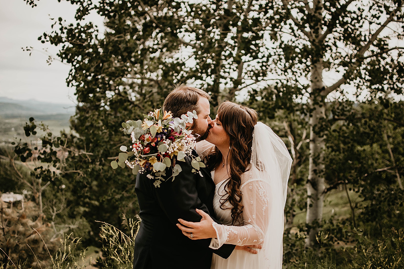 Rustic Colorado Elopement Ceremony First Kiss by Krystal Capone Photography