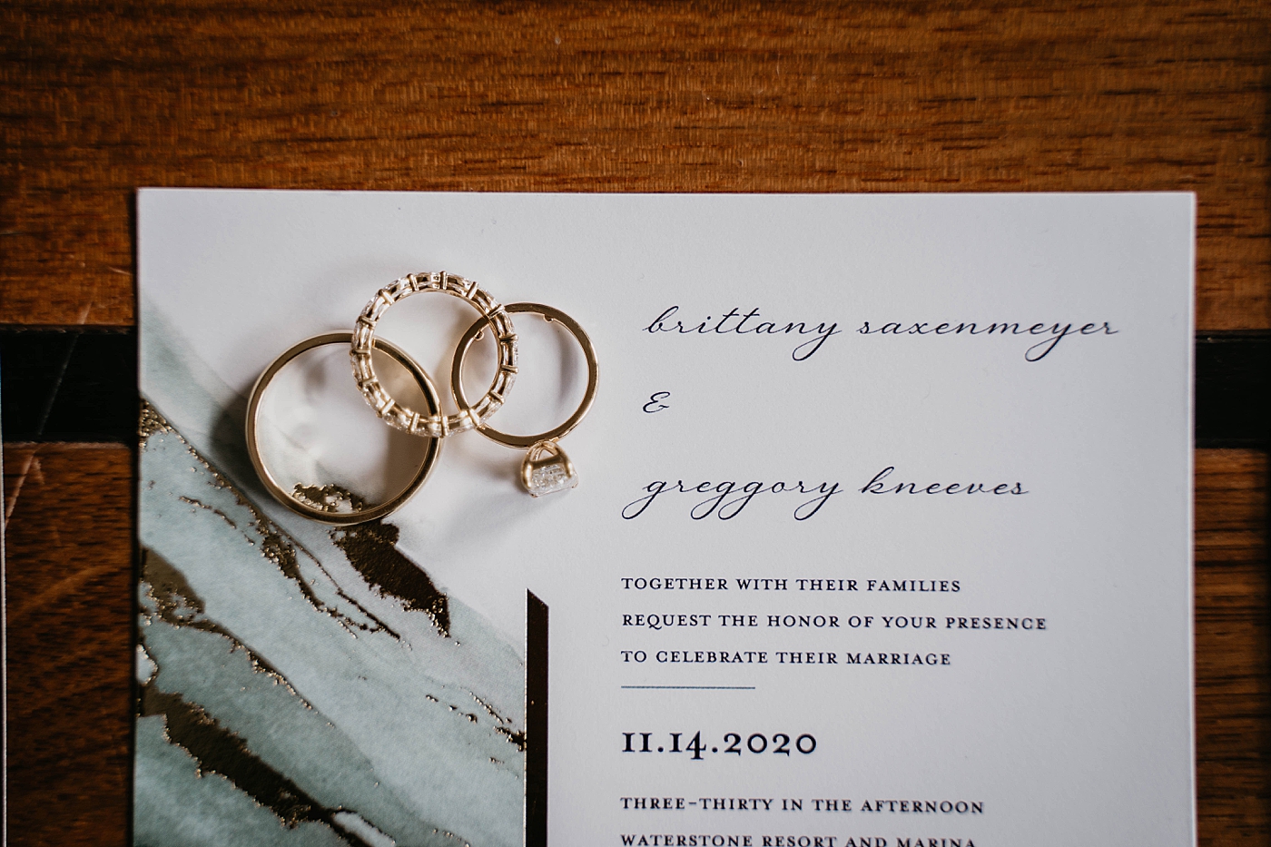 Wedding bands on top of invitation wedding details Waterstone Resort and Marina Wedding captured by South Florida Wedding Photographer Krystal Capone Photography