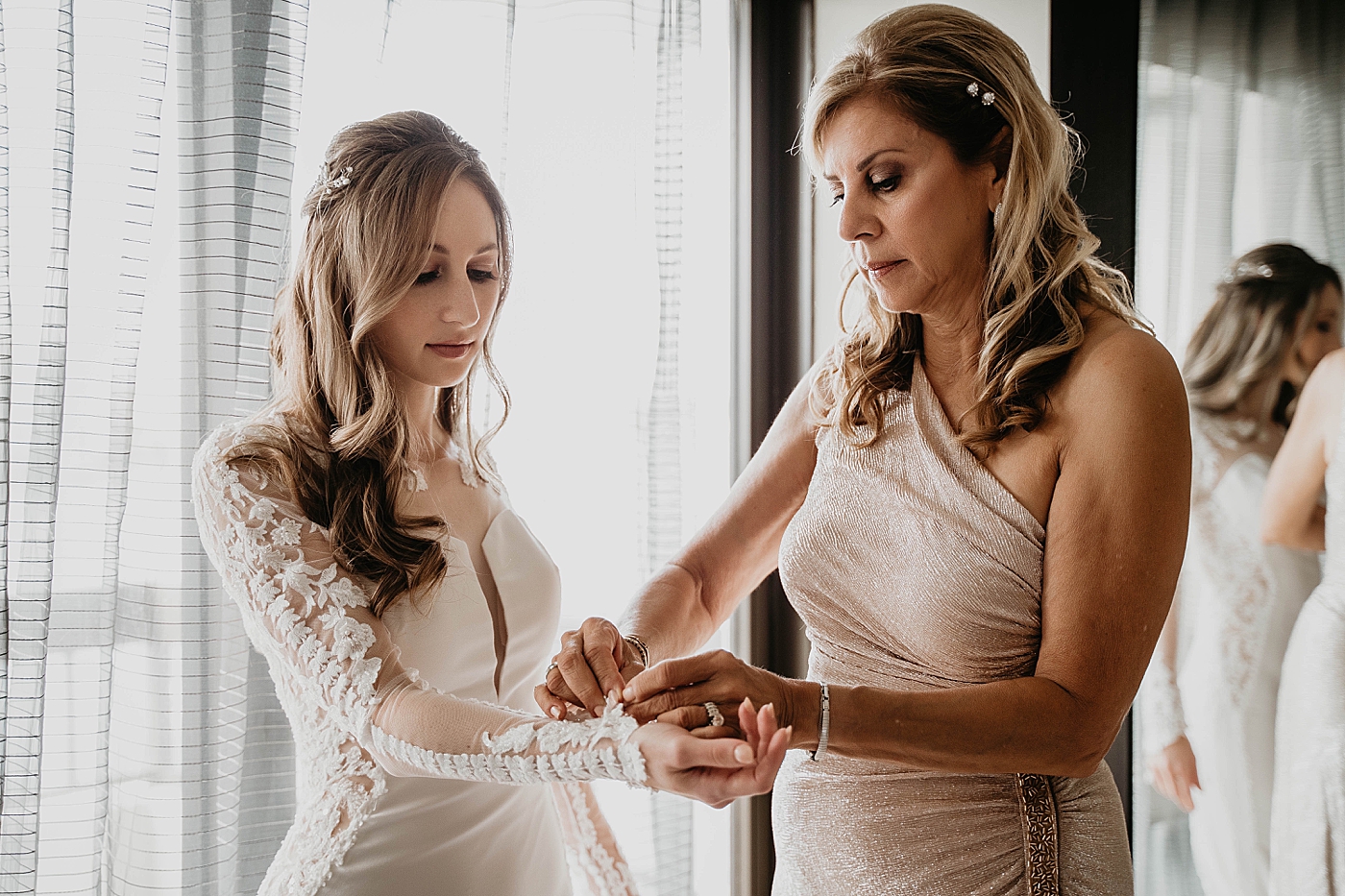 Getting Ready detail shot of finishing the sleeves Waterstone Resort and Marina Wedding captured by South Florida Wedding Photographer Krystal Capone Photography