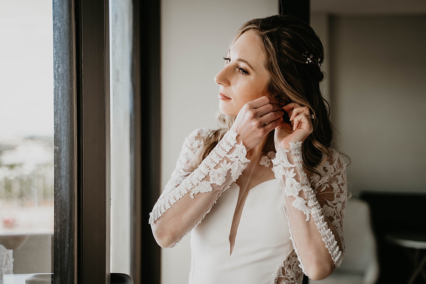 Bride putting earrings on Waterstone Resort and Marina Wedding captured by South Florida Wedding Photographer Krystal Capone Photography