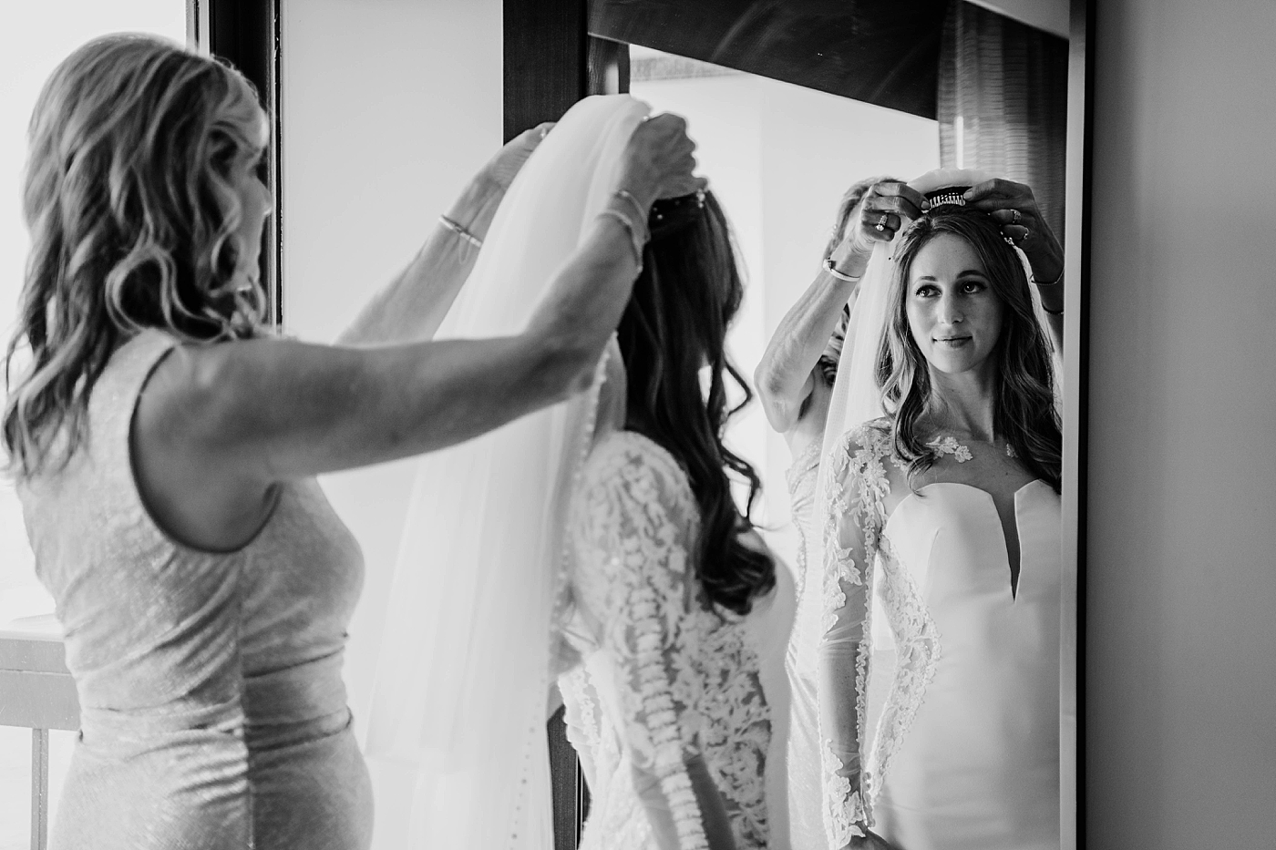 B&W Bride putting on veil Waterstone Resort and Marina Wedding captured by South Florida Wedding Photographer Krystal Capone Photography