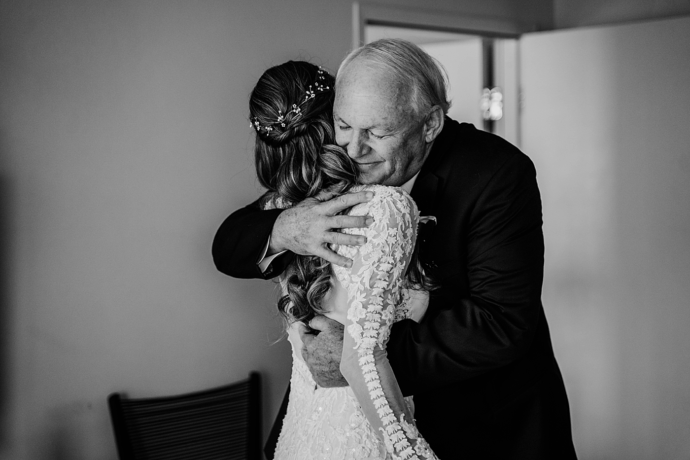 Bride hugging family Black and white Waterstone Resort and Marina Wedding captured by South Florida Wedding Photographer Krystal Capone Photography