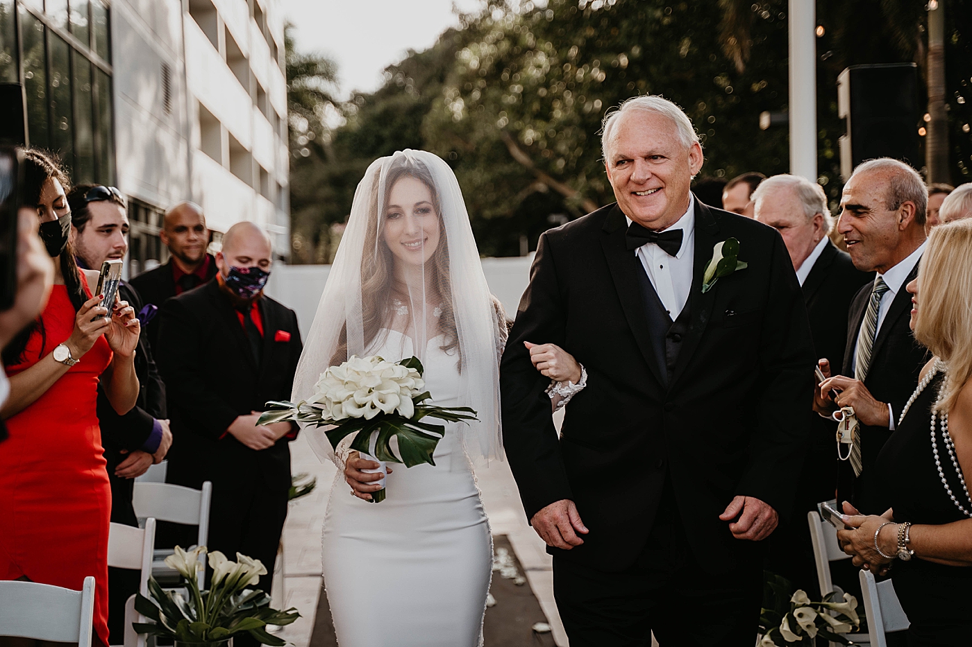 Bride coming down the aisle Waterstone Resort and Marina Wedding captured by South Florida Wedding Photographer Krystal Capone Photography