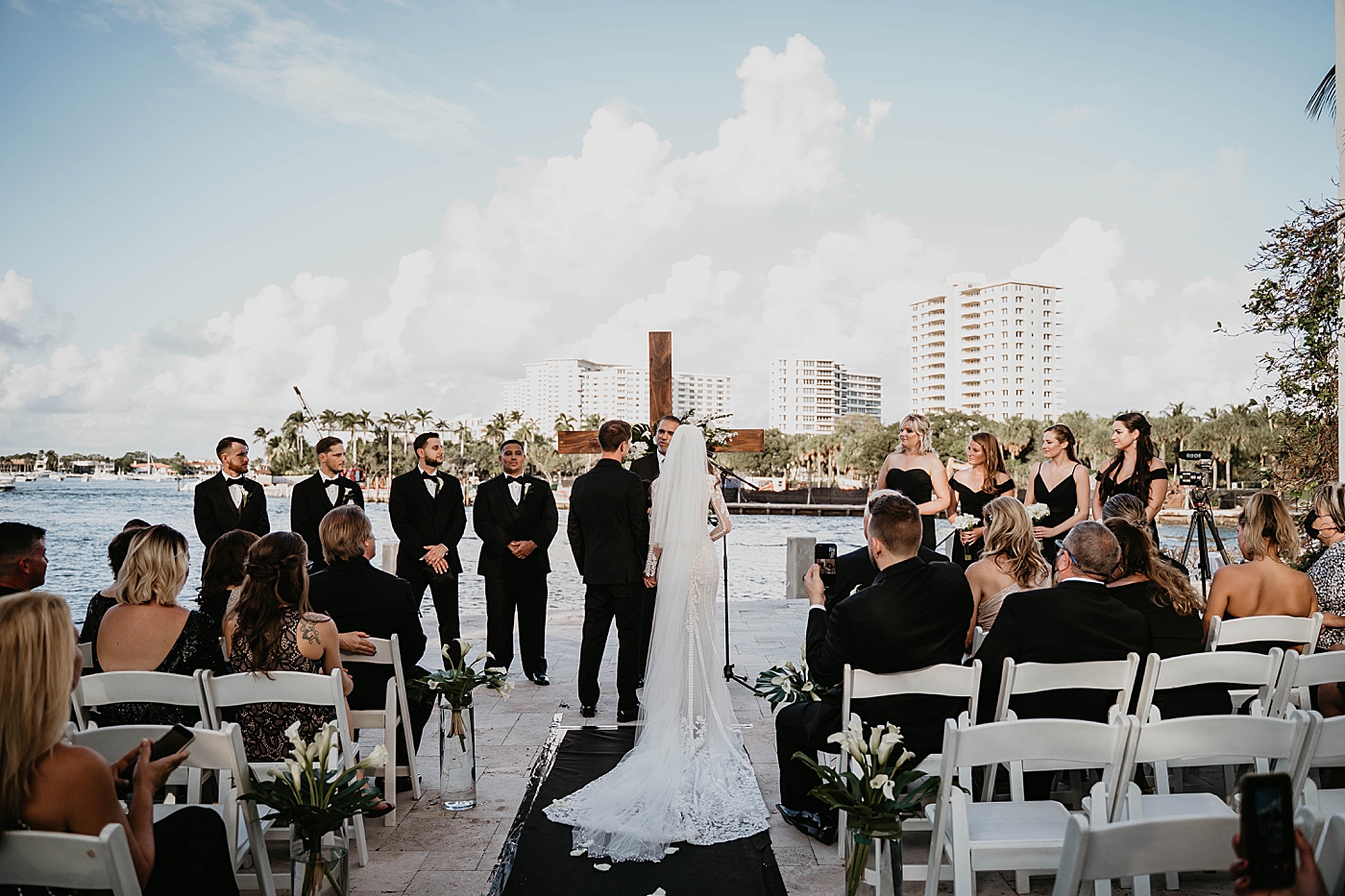 Wideshot of ceremony with waterside in the back Waterstone Resort and Marina Wedding captured by South Florida Wedding Photographer Krystal Capone Photography