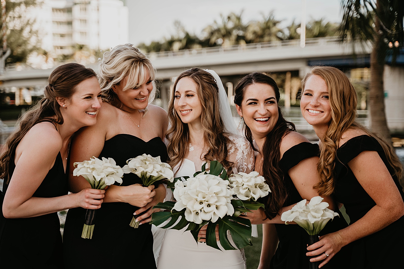Bride and Bridesmaids with bouquets Waterstone Resort and Marina Wedding captured by South Florida Wedding Photographer Krystal Capone Photography