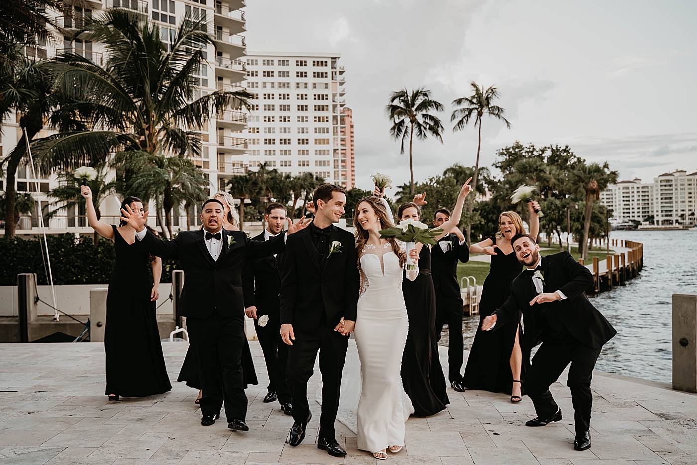Fun walking forward pic with the whole Bridal party Waterstone Resort and Marina Wedding captured by South Florida Wedding Photographer Krystal Capone Photography