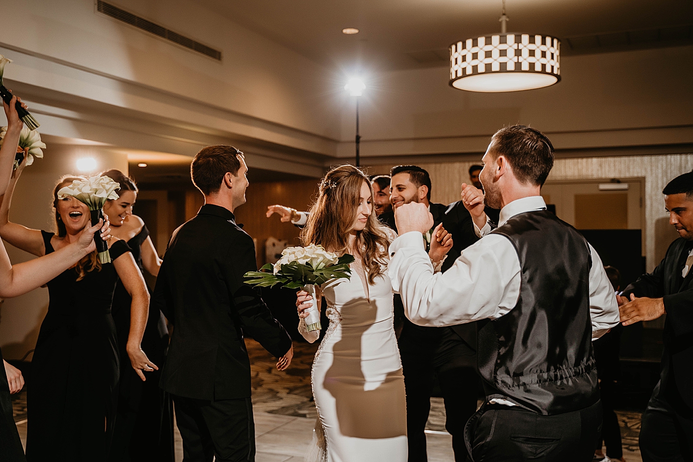 Candid shot of dancing at the reception Waterstone Resort and Marina Wedding captured by South Florida Wedding Photographer Krystal Capone Photography