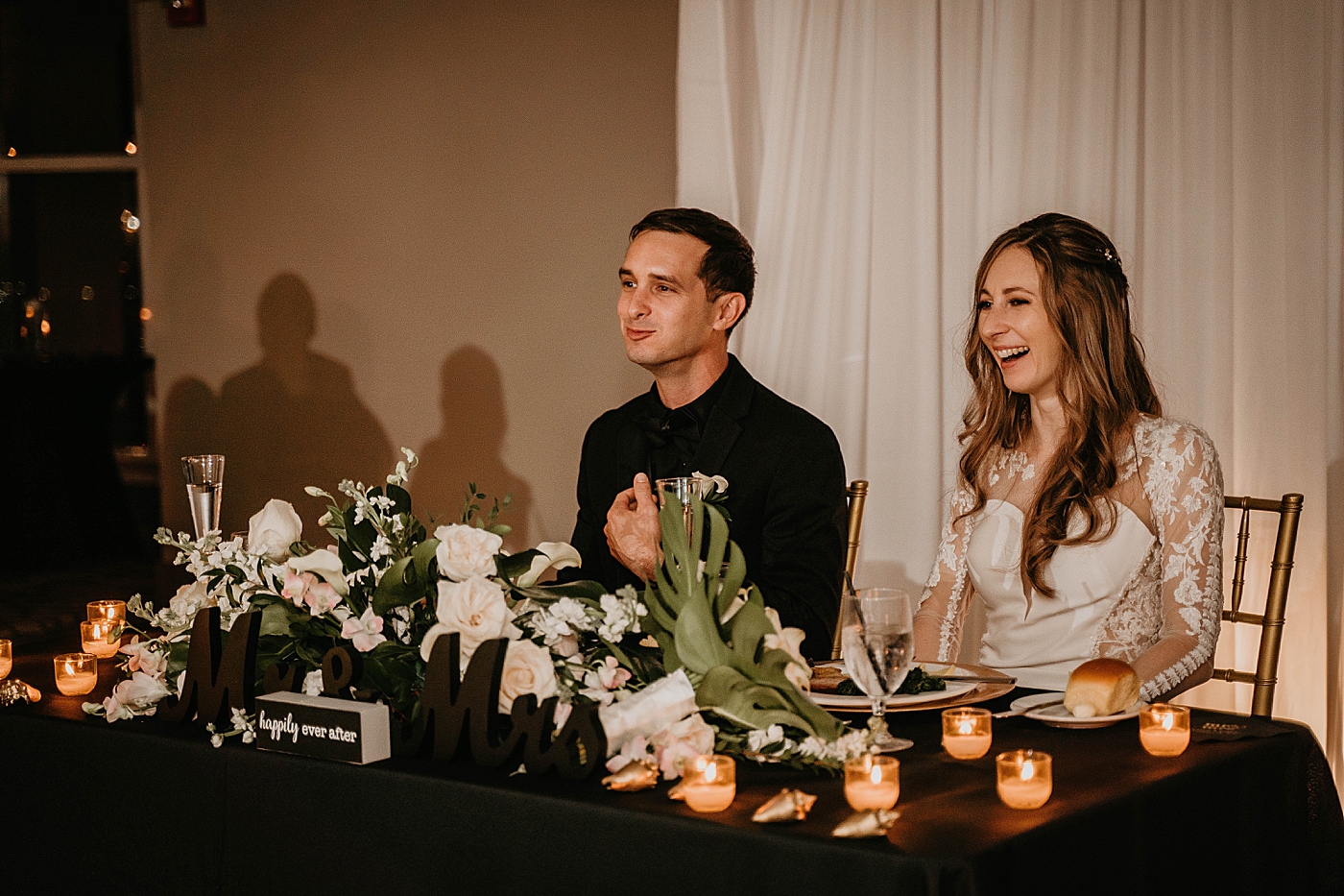 Floral Sweetheart table with happy Bride and Groom Waterstone Resort and Marina Wedding captured by South Florida Wedding Photographer Krystal Capone Photography