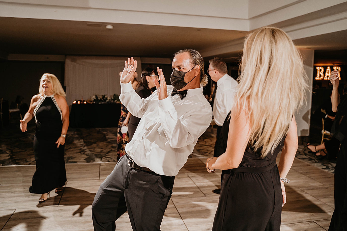 Candid mask on dancing Waterstone Resort and Marina Wedding captured by South Florida Wedding Photographer Krystal Capone Photography