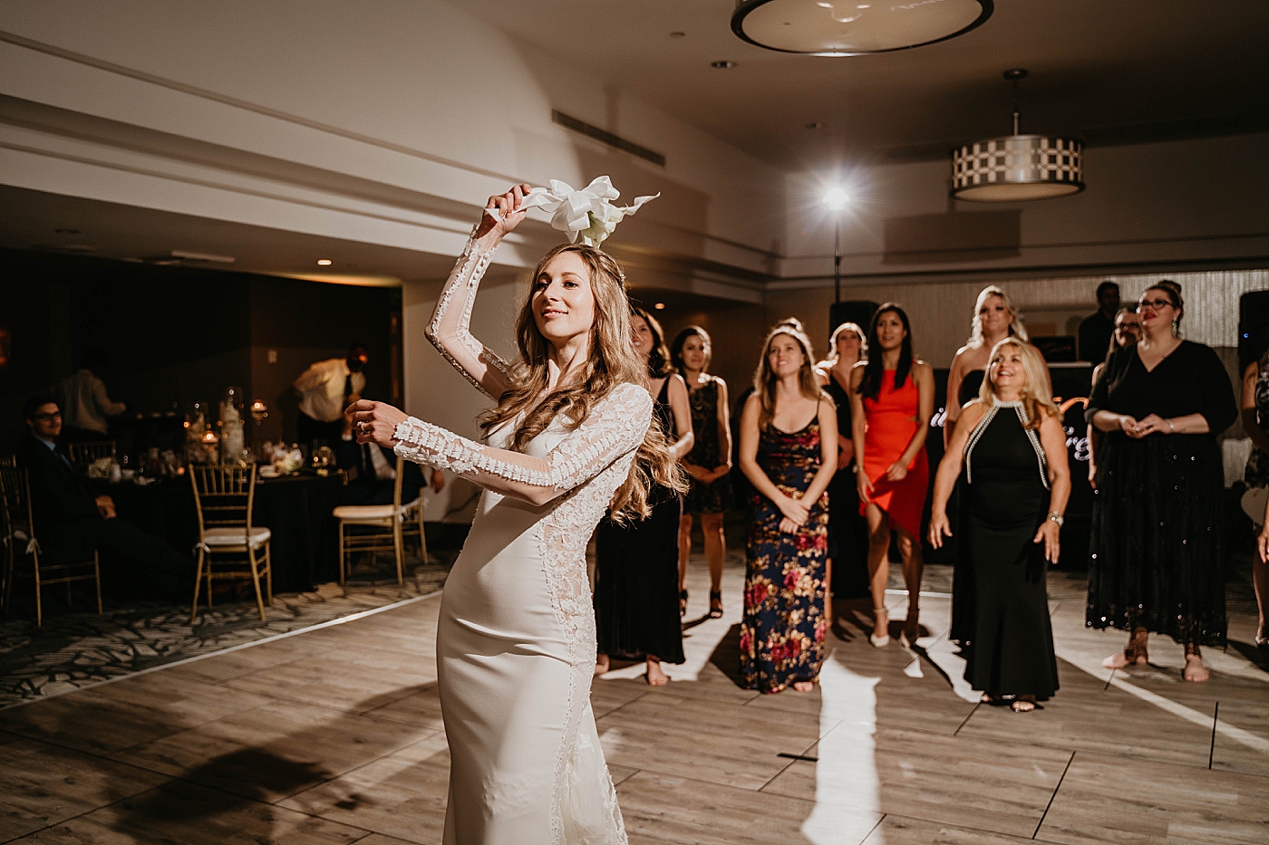 Bouquet toss Waterstone Resort and Marina Wedding captured by South Florida Wedding Photographer Krystal Capone Photography