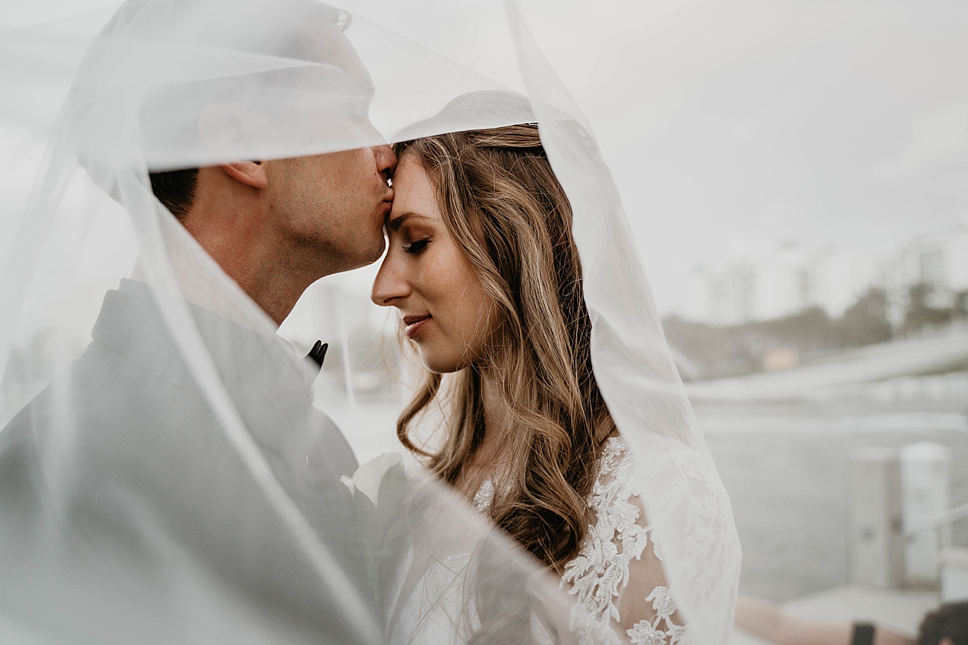 Bride and Groom under veil Waterstone Resort and Marina Wedding captured by South Florida Wedding Photographer Krystal Capone Photography