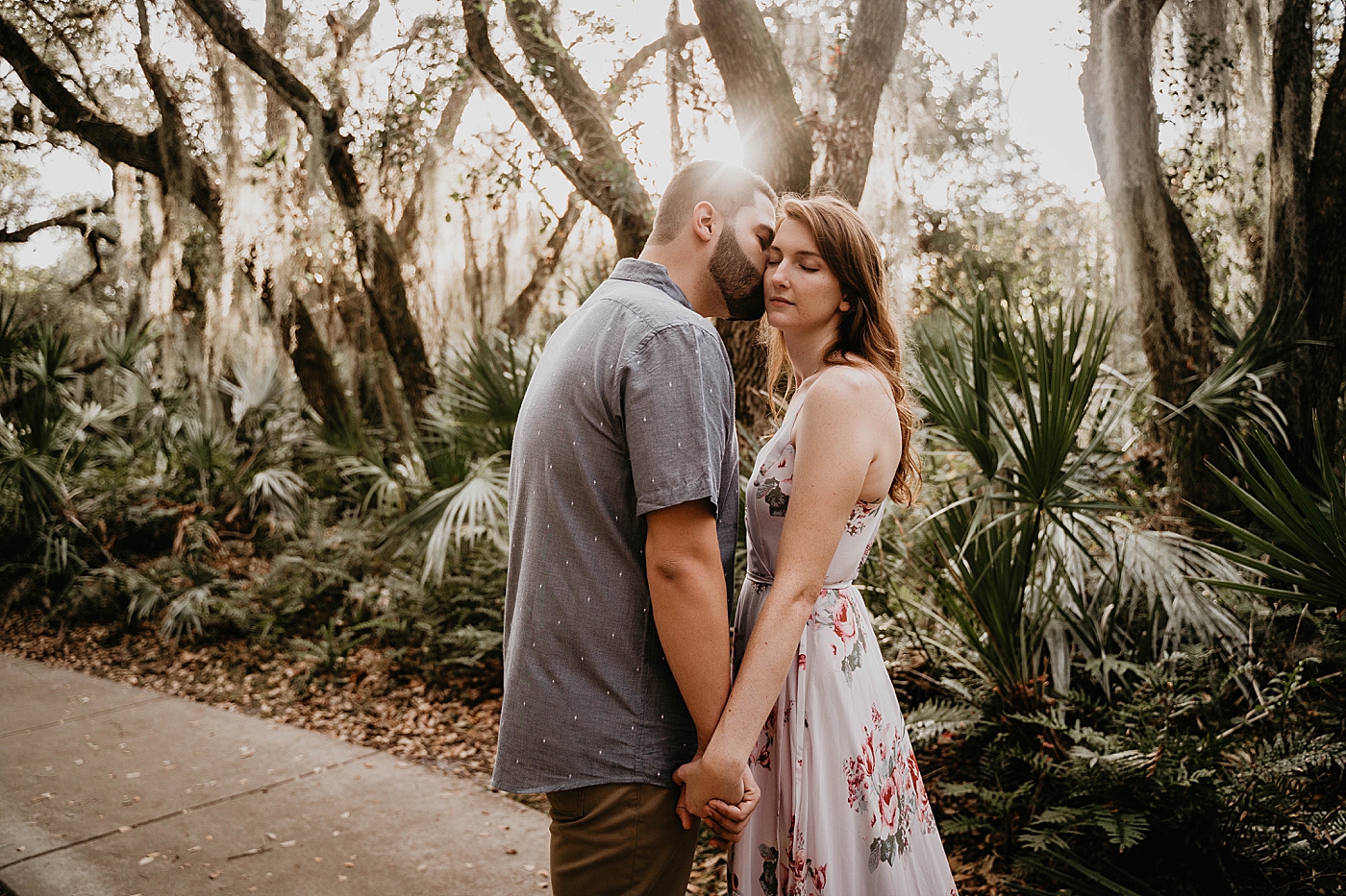 Man kissing lady on the cheek Delray Oaks Engagement Photography captured by South Florida Engagement Photographer Krystal Capone Photography