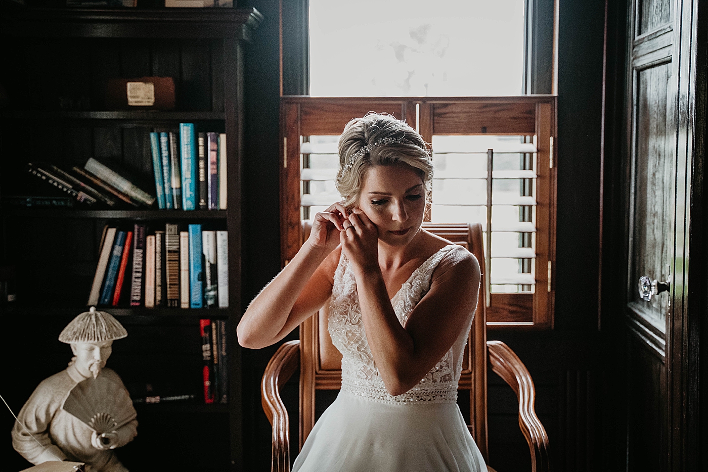 Bride putting earring on getting ready The Estate on the Halifax Wedding Photography captured by South Florida Wedding Photographer Krystal Capone Photography 