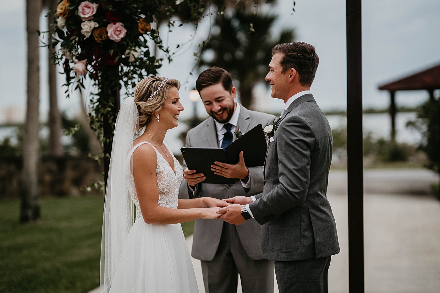 Bride and Groom holding hands during Homily Ceremony The Estate on the Halifax Wedding Photography captured by South Florida Wedding Photographer Krystal Capone Photography 