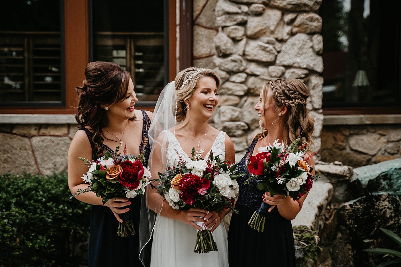 Bride and Bridesmaid portrait with red bouquets The Estate on the Halifax Wedding Photography captured by South Florida Wedding Photographer Krystal Capone Photography 