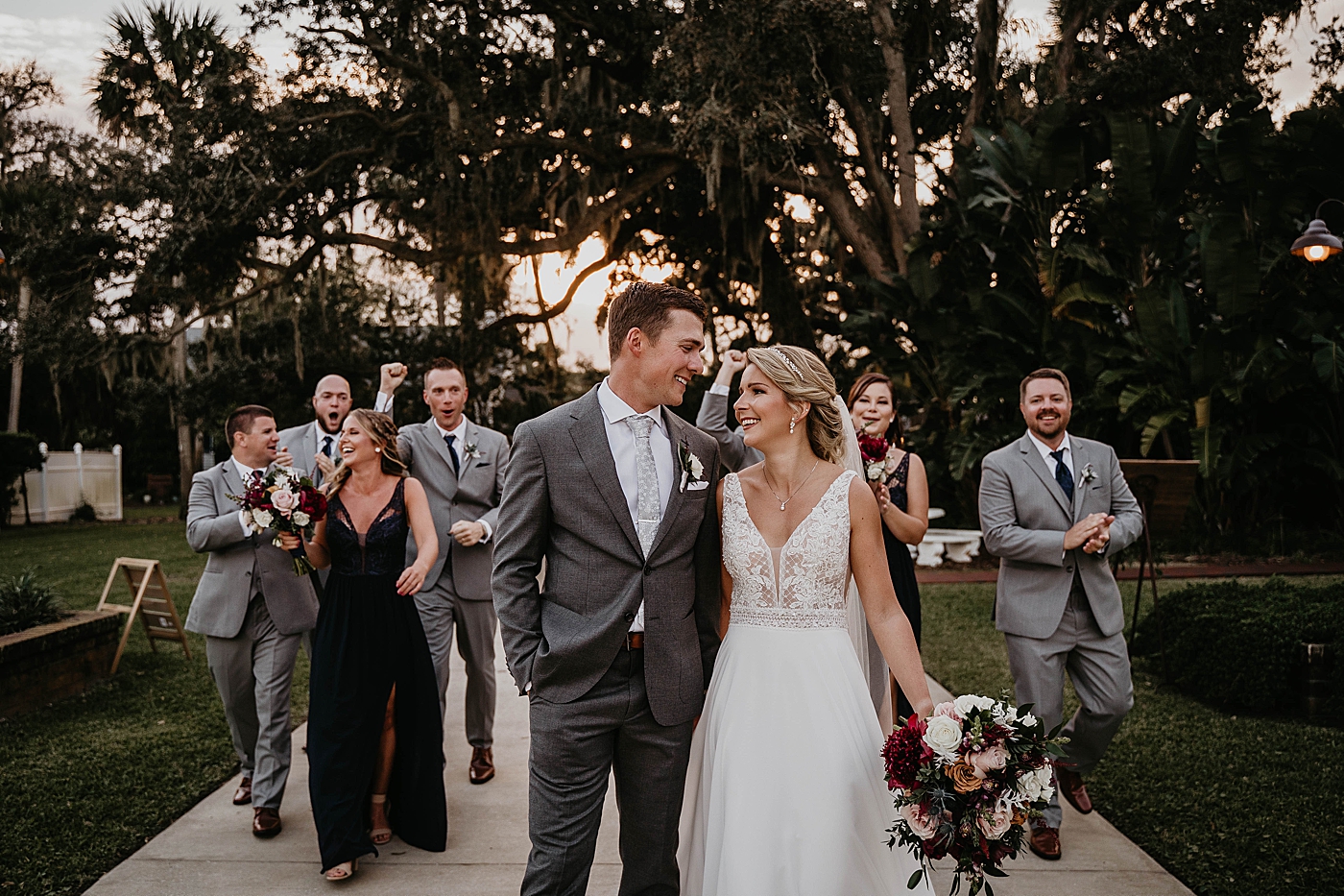 Bride and Groom walking together with Wedding party behind them The Estate on the Halifax Wedding Photography captured by South Florida Wedding Photographer Krystal Capone Photography 