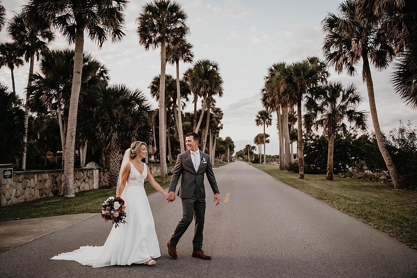 Bride and Groom holding hands crossing the street The Estate on the Halifax Wedding Photography captured by South Florida Wedding Photographer Krystal Capone Photography 
