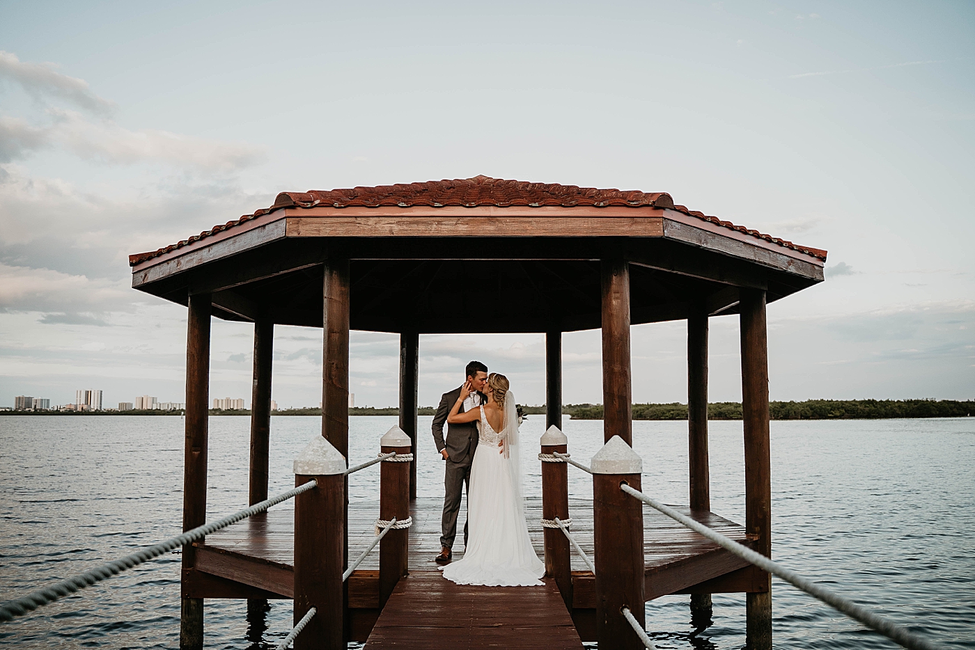 Bride and Groom kissing by the ocean The Estate on the Halifax Wedding Photography captured by South Florida Wedding Photographer Krystal Capone Photography 