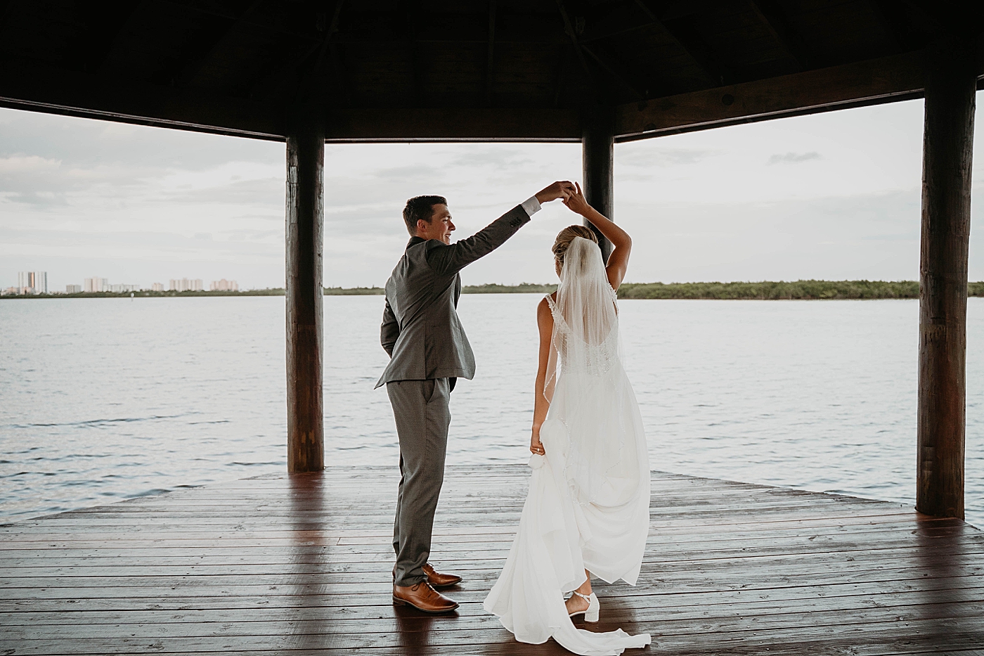 bride and Groom pirouetting by the oceanside The Estate on the Halifax Wedding Photography captured by South Florida Wedding Photographer Krystal Capone Photography  