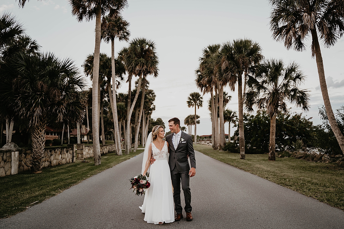 Bride and groom holding each other and walking The Estate on the Halifax Wedding Photography captured by South Florida Wedding Photographer Krystal Capone Photography 
