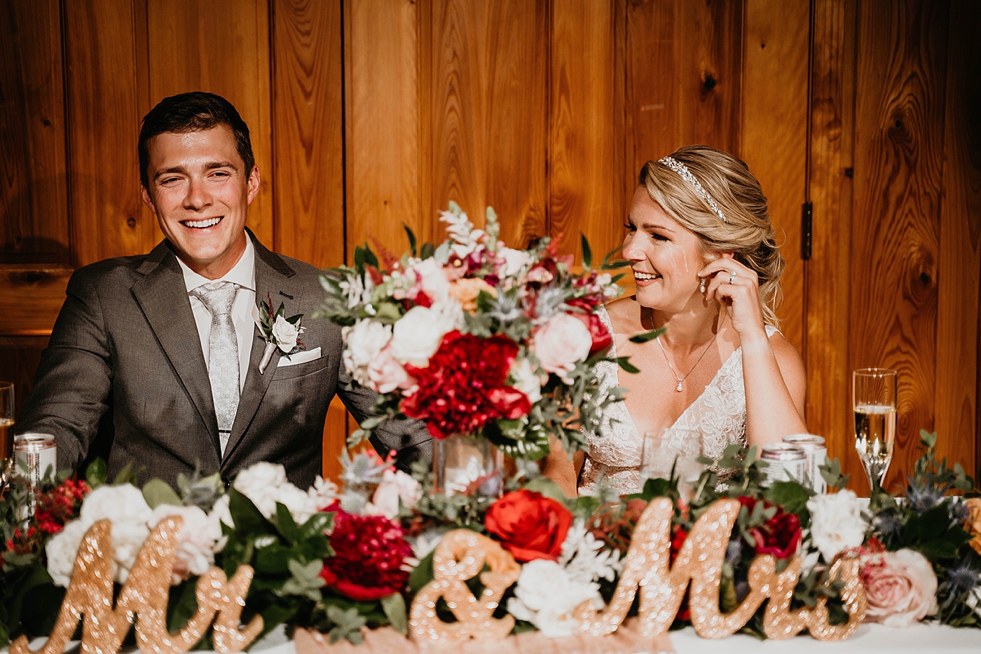 Bride and Groom at sweetheart table The Estate on the Halifax Wedding Photography captured by South Florida Wedding Photographer Krystal Capone Photography 