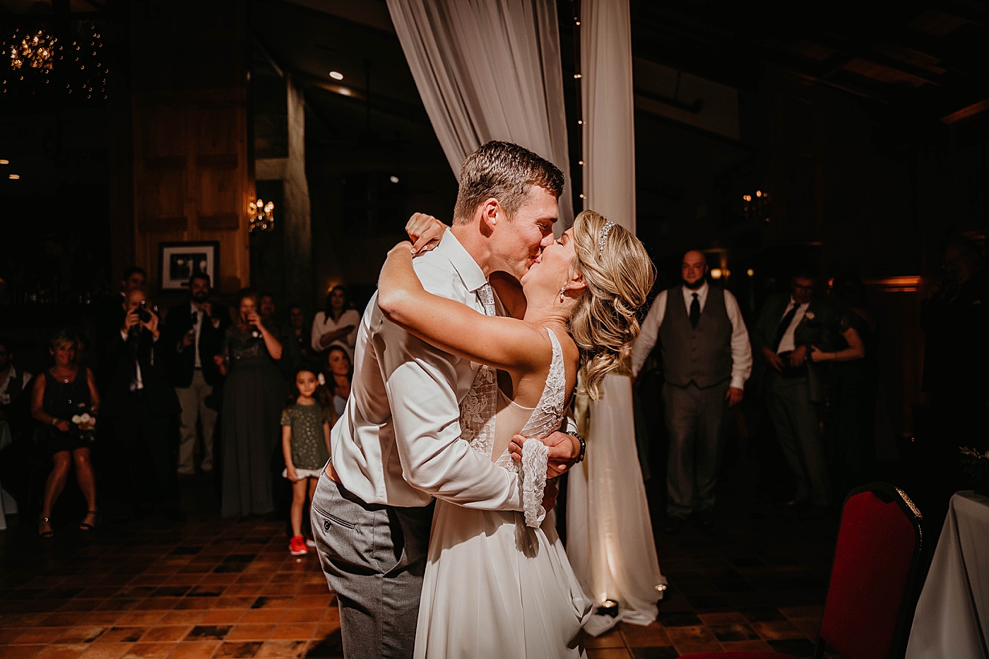 Bride and Groom kissing after getting garter The Estate on the Halifax Wedding Photography captured by South Florida Wedding Photographer Krystal Capone Photography 