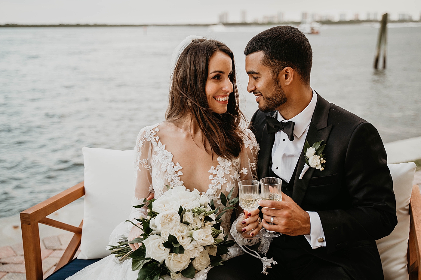 Bride and Groom having some Champaign by the water Intimate Home Wedding captured by South Florida Wedding Photographer Krystal Capone Photography