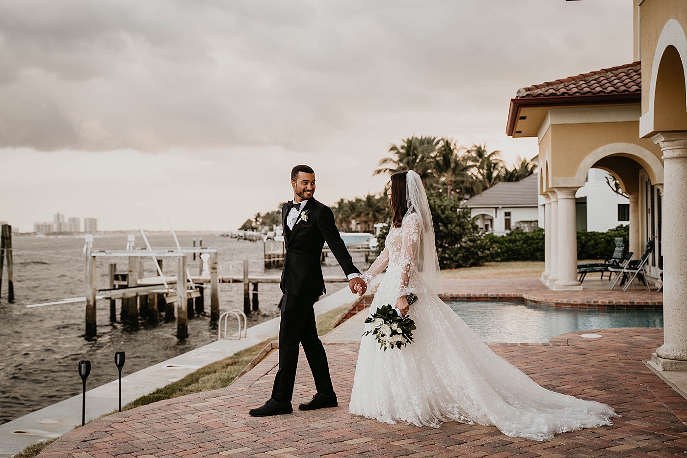 Bride and Groom holding hands Intimate Home Wedding captured by South Florida Wedding Photographer Krystal Capone Photography