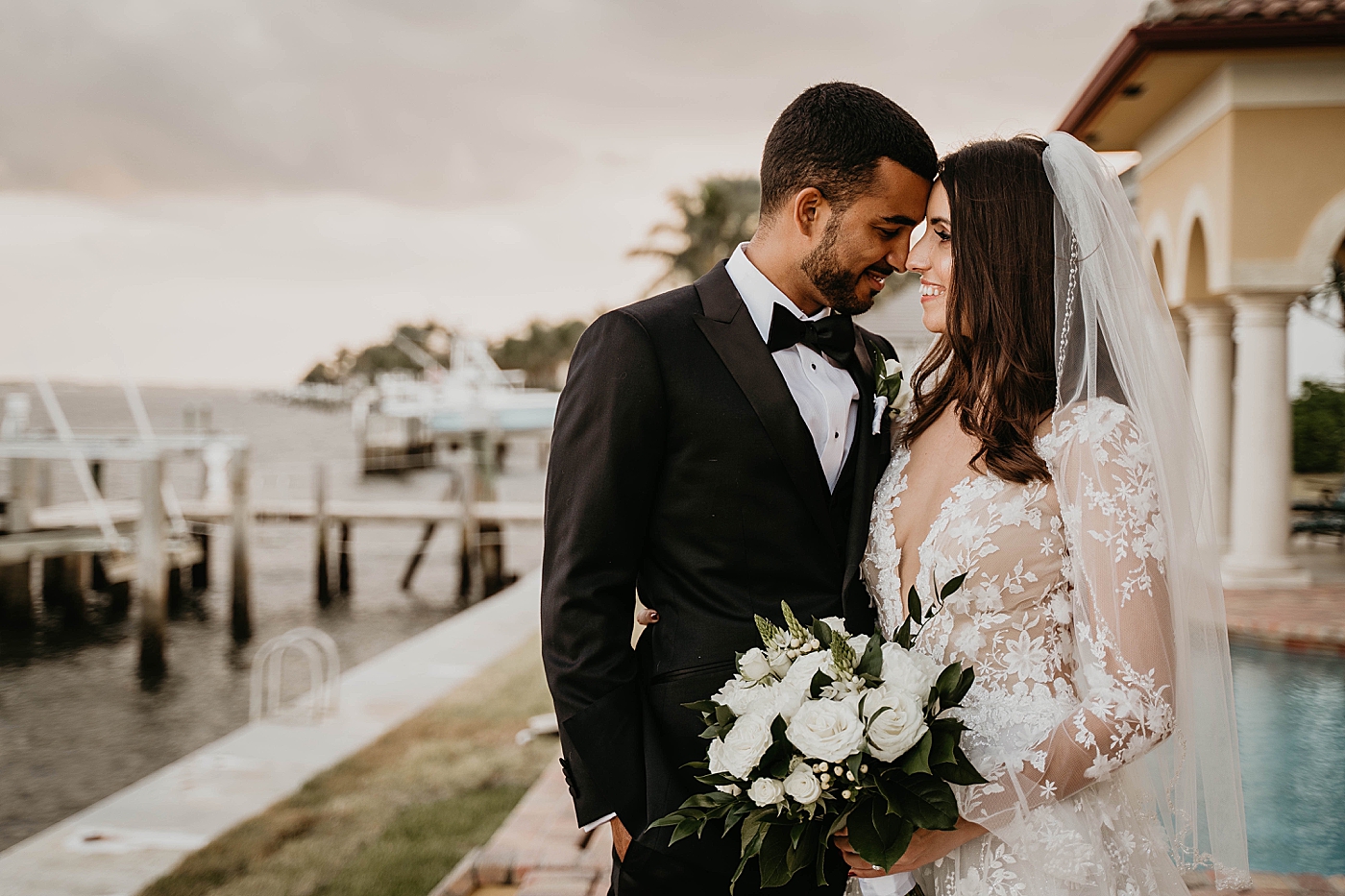 Bride and Groom nuzzling by their house Intimate Home Wedding captured by South Florida Wedding Photographer Krystal Capone Photography
