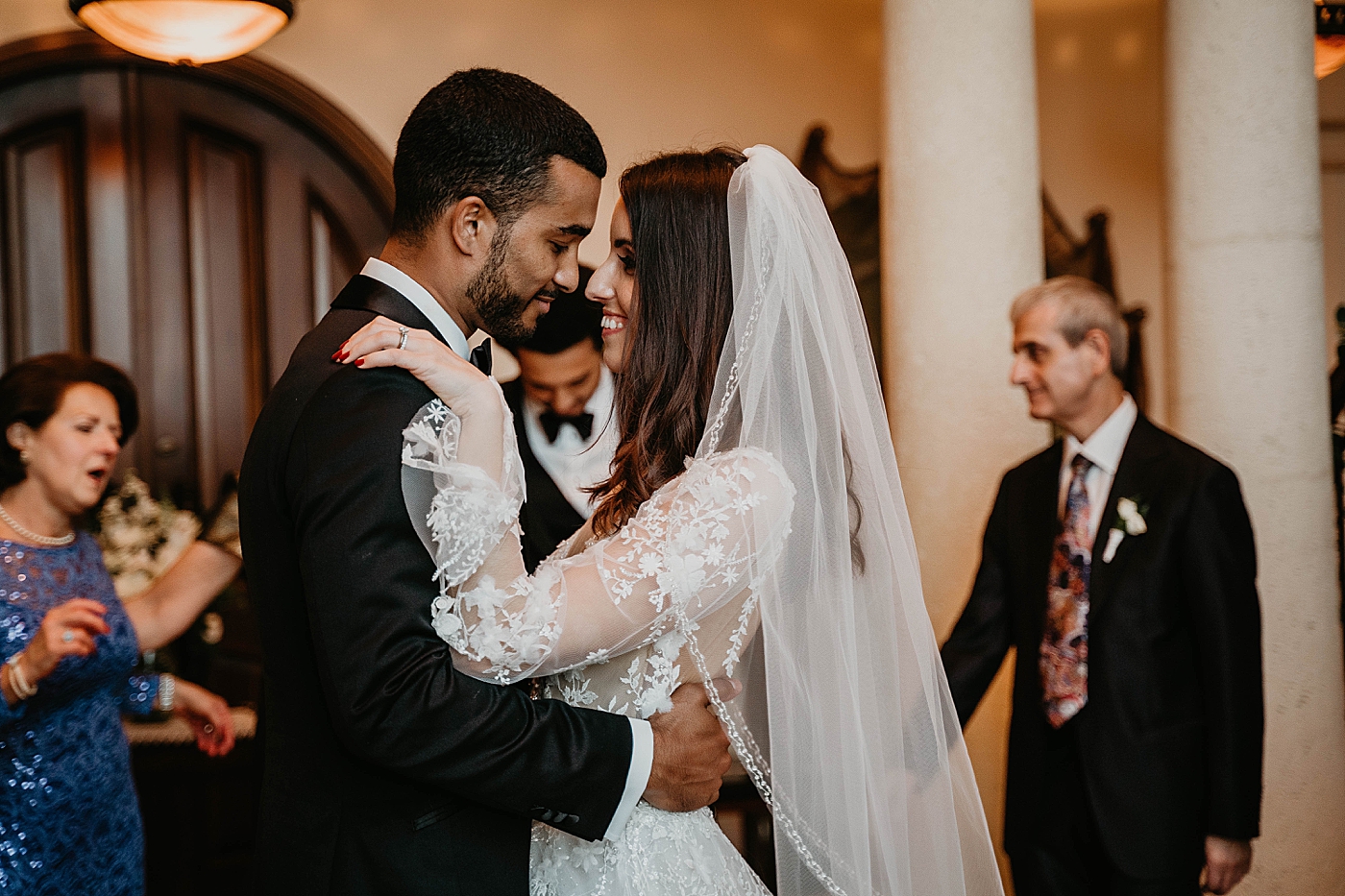 Bride and Groom holding each other during first dance Intimate Home Wedding captured by South Florida Wedding Photographer Krystal Capone Photography