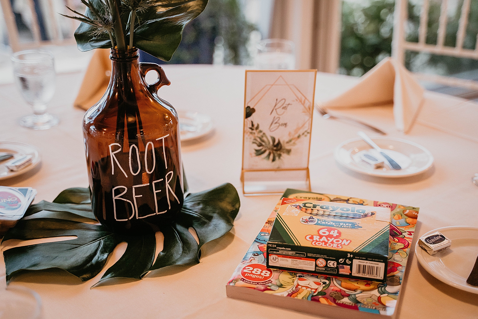 Detail shot of bottle of flower piece and coloring books at reception table Jupiter Lighthouse Wedding Photography captured by South Florida Wedding Photographer Krystal Capone Photography