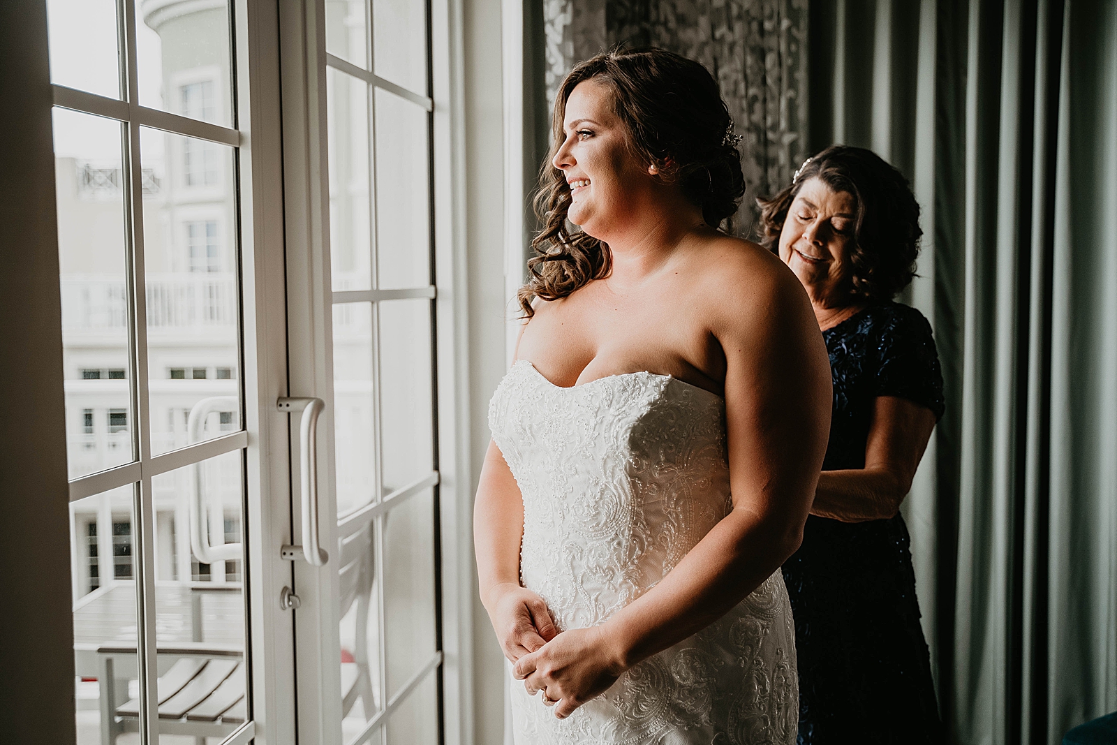 Bride getting ready by the window Jupiter Lighthouse Wedding Photography captured by South Florida Wedding Photographer Krystal Capone Photography