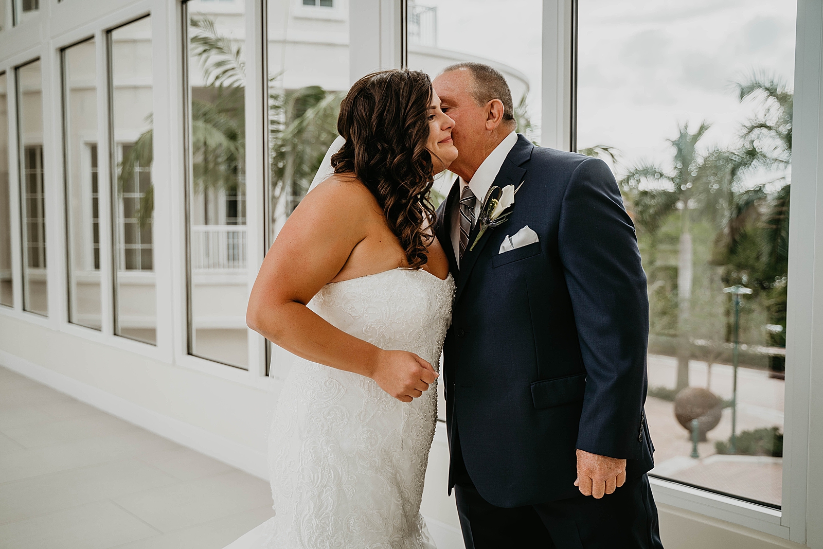 Father and daughter hugging Jupiter Lighthouse Wedding Photography captured by South Florida Wedding Photographer Krystal Capone Photography