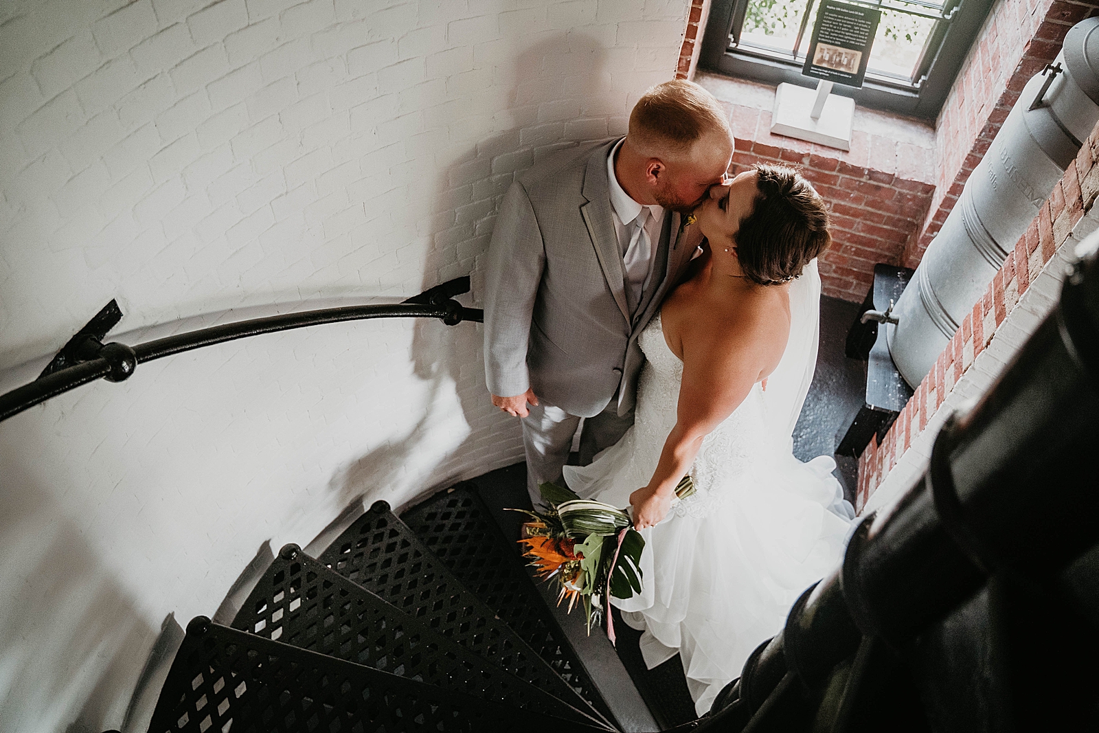 Bride and Groom kissing on Lighthouse stairway Jupiter Lighthouse Wedding Photography captured by South Florida Wedding Photographer Krystal Capone Photography