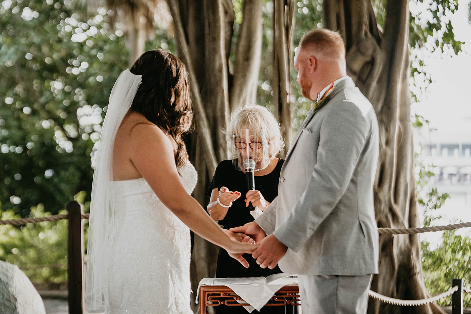Ceremony with officiant face shield staying safe Jupiter Lighthouse Wedding Photography captured by South Florida Wedding Photographer Krystal Capone Photography
