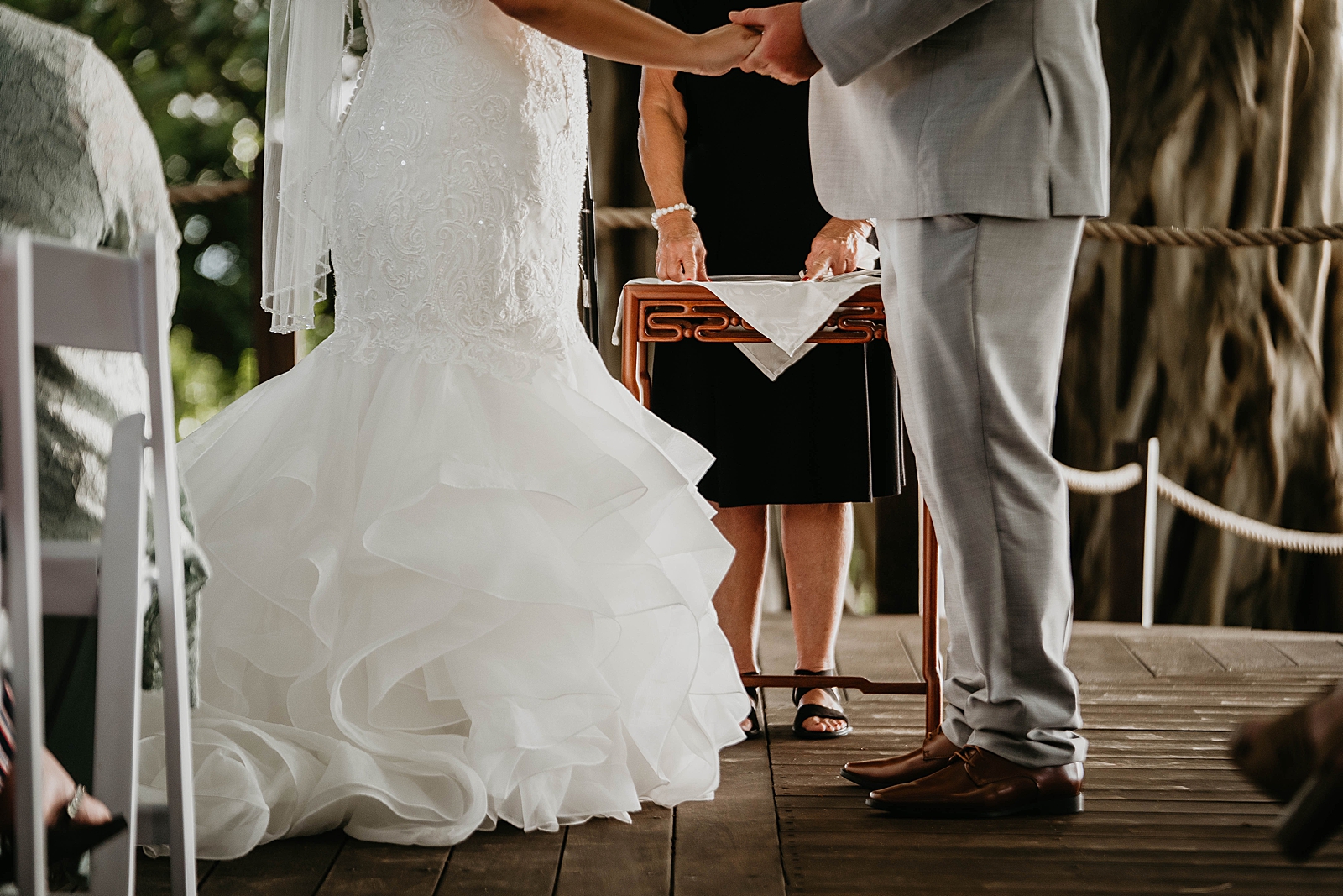 Lower half shot of Bride and Groom holding hands and saying I Do's Jupiter Lighthouse Wedding Photography captured by South Florida Wedding Photographer Krystal Capone Photography