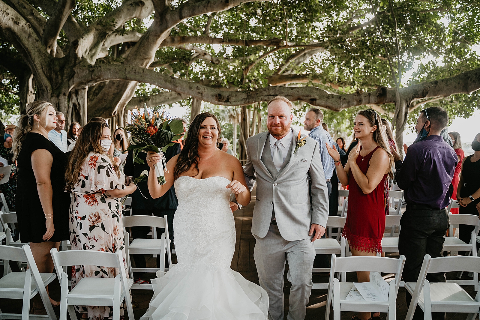Bride and Groom just married exiting Jupiter Lighthouse Wedding Photography captured by South Florida Wedding Photographer Krystal Capone Photography