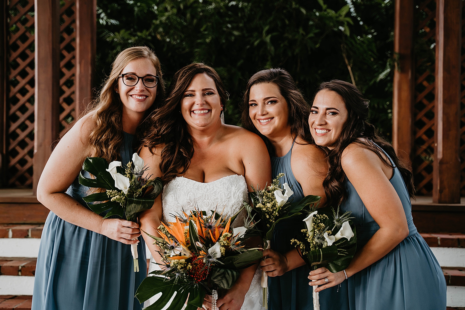 Bride with Bridesmaids holding bouquets Jupiter Lighthouse Wedding Photography captured by South Florida Wedding Photographer Krystal Capone Photography