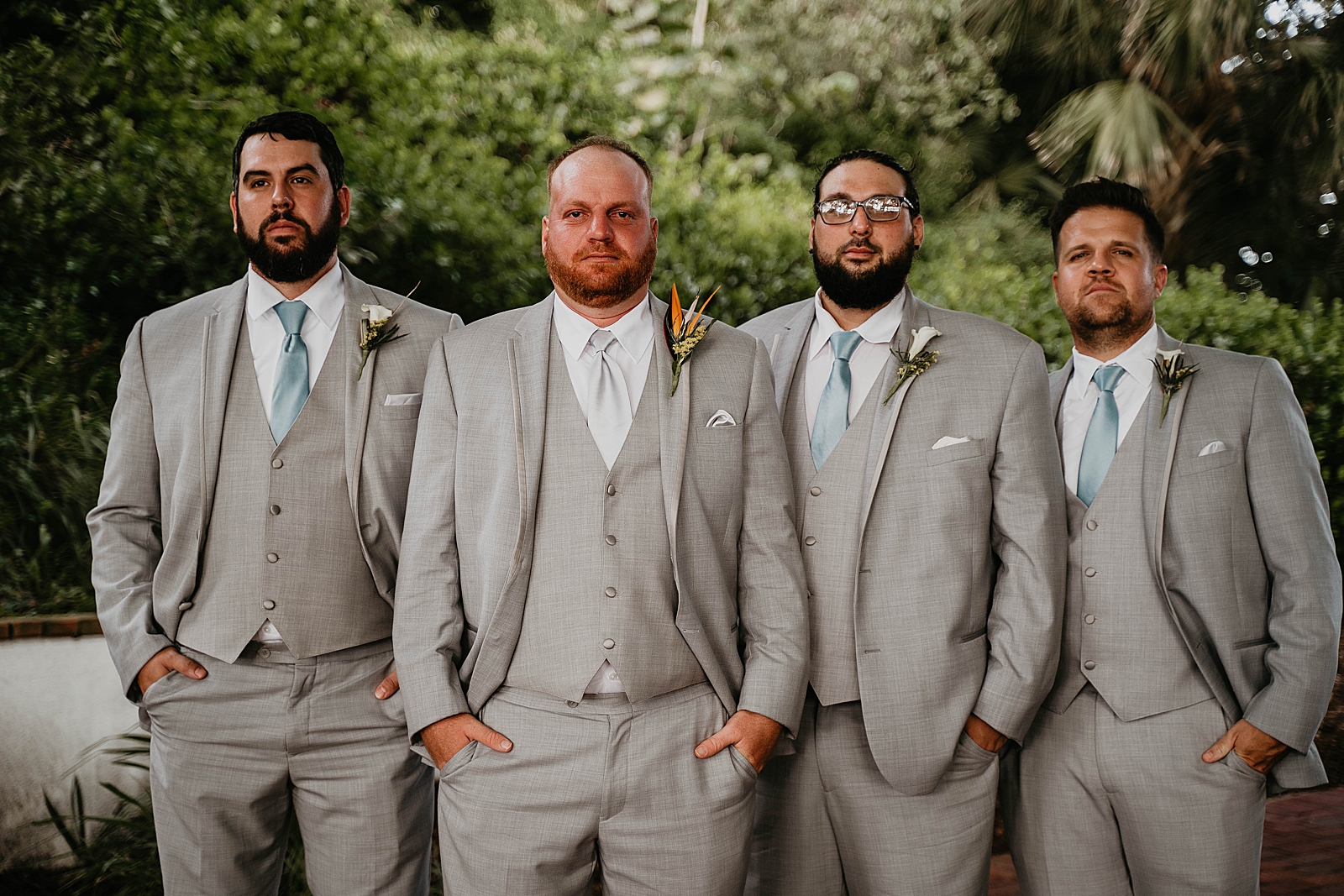 Groom with groomsmen with hands in pocket looking dapper Jupiter Lighthouse Wedding Photography captured by South Florida Wedding Photographer Krystal Capone Photography