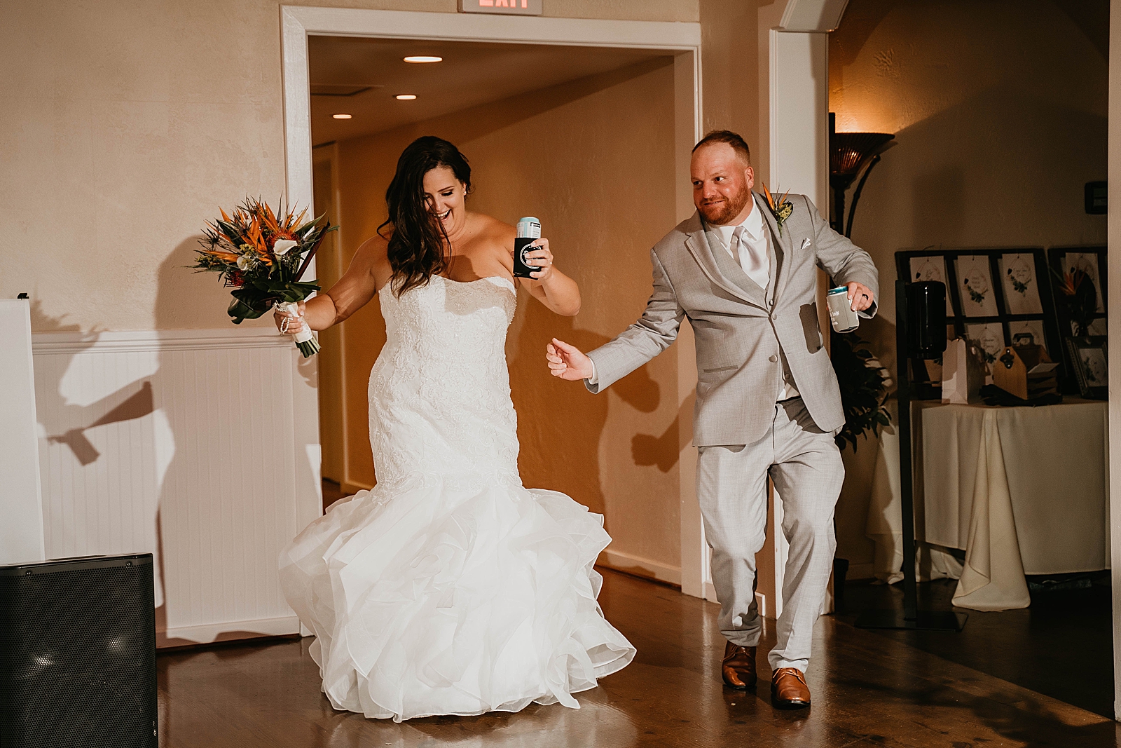 Bride and Groom having fun entering the Reception Jupiter Lighthouse Wedding Photography captured by South Florida Wedding Photographer Krystal Capone Photography
