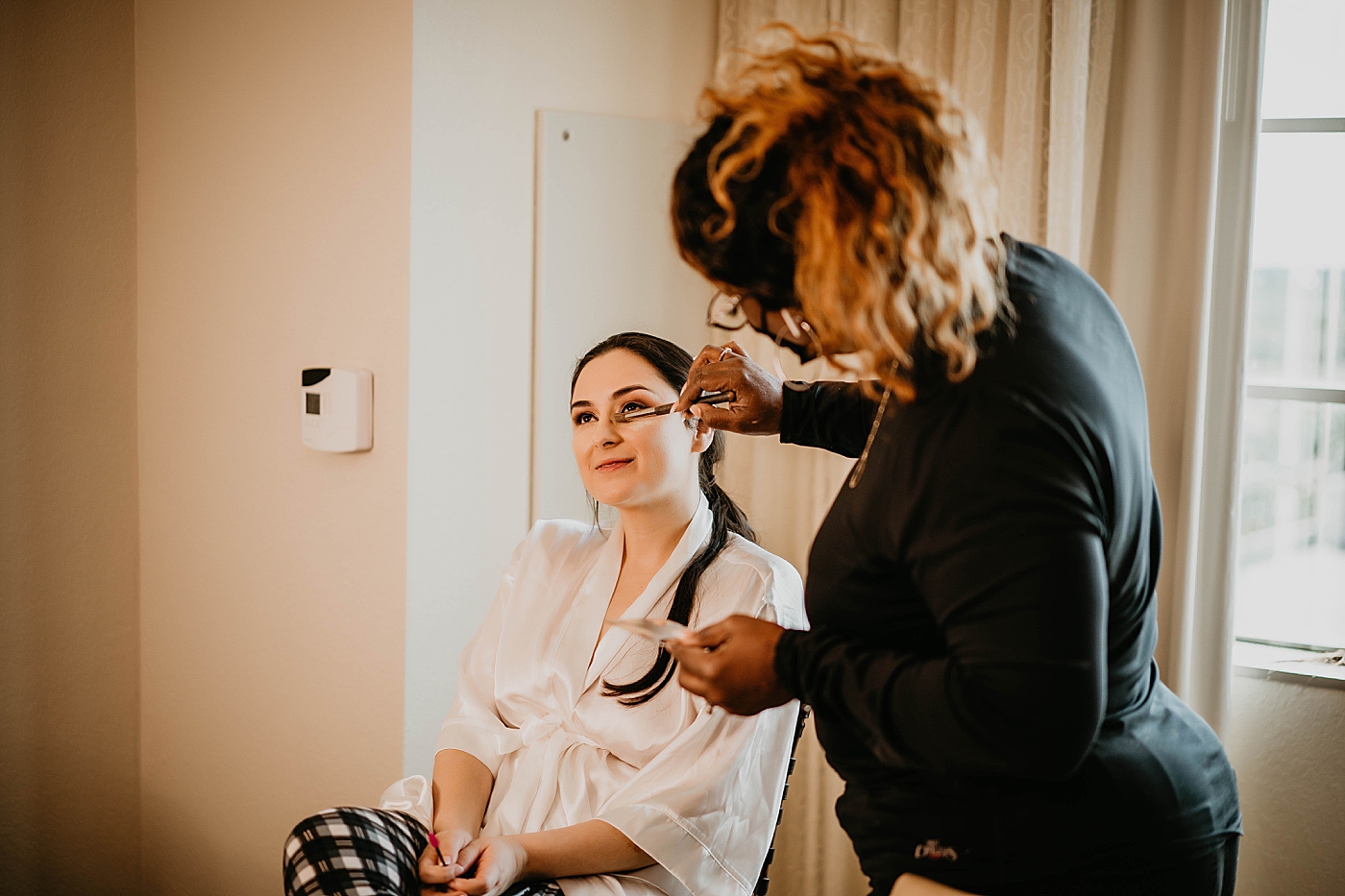 Bride getting makeup done Getting Ready Lavan Venue Wedding Photography captured by South Florida Wedding Photographer Krystal Capone Photography