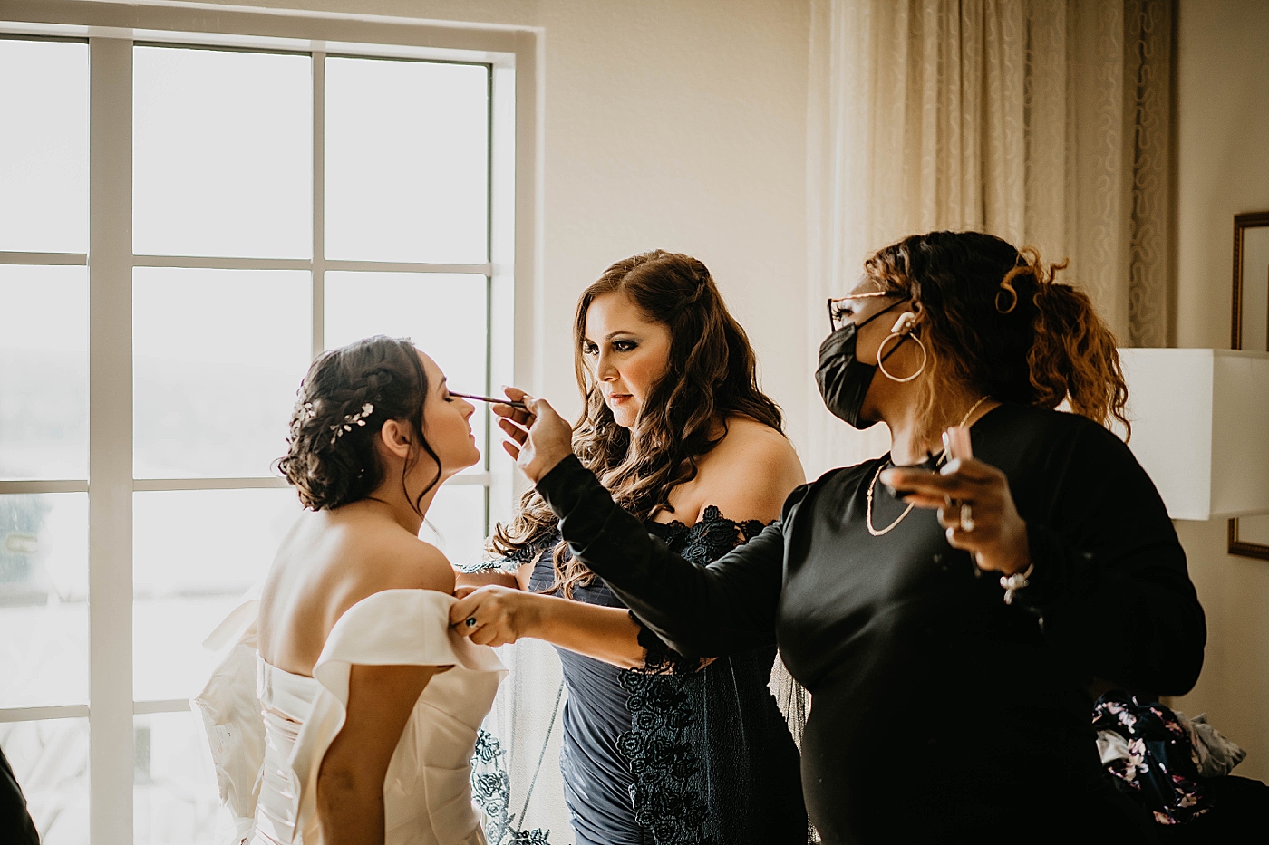 Bride getting dress on and getting finishing touches on makeup Lavan Venue Wedding Photography captured by South Florida Wedding Photographer Krystal Capone Photography