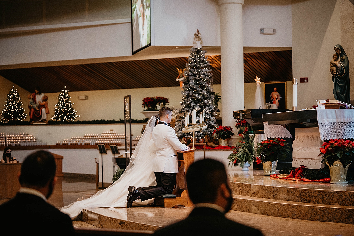 Bride and Groom at the alter with Christmas decor Lavan Venue Wedding Photography captured by South Florida Wedding Photographer Krystal Capone Photography