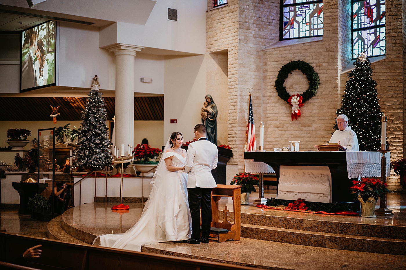 Bride and Groom holding hands at Ceremony with Christmas Decor Lavan Venue Wedding Photography captured by South Florida Wedding Photographer Krystal Capone Photography