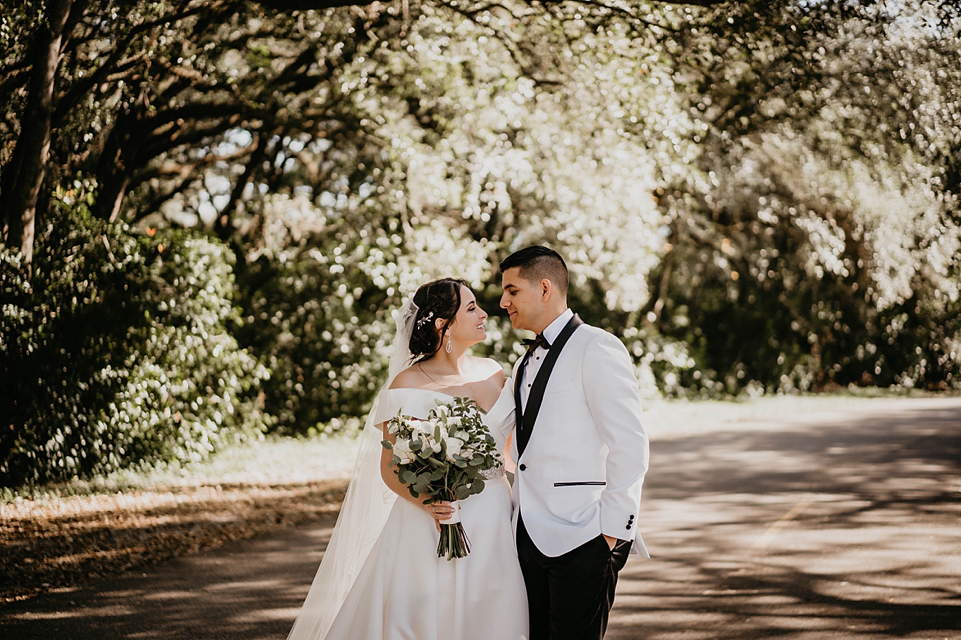 Bride and Groom close to each other looking into each others eyes on path Lavan Venue Wedding Photography captured by South Florida Wedding Photographer Krystal Capone Photography