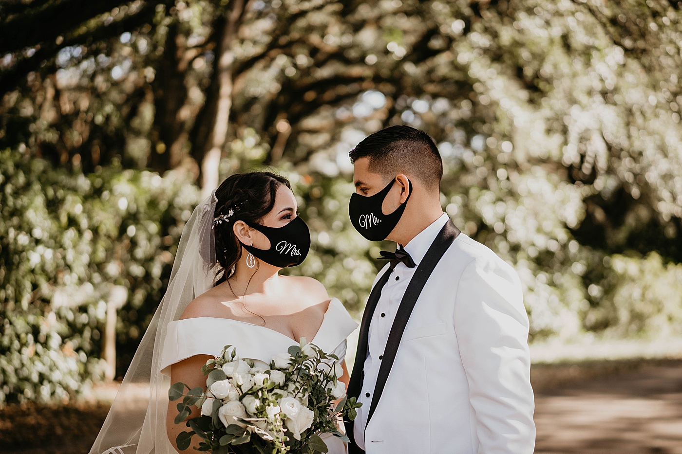 Bride and Groom looking at ech other in personalized wedding masks Lavan Venue Wedding Photography captured by South Florida Wedding Photographer Krystal Capone Photography