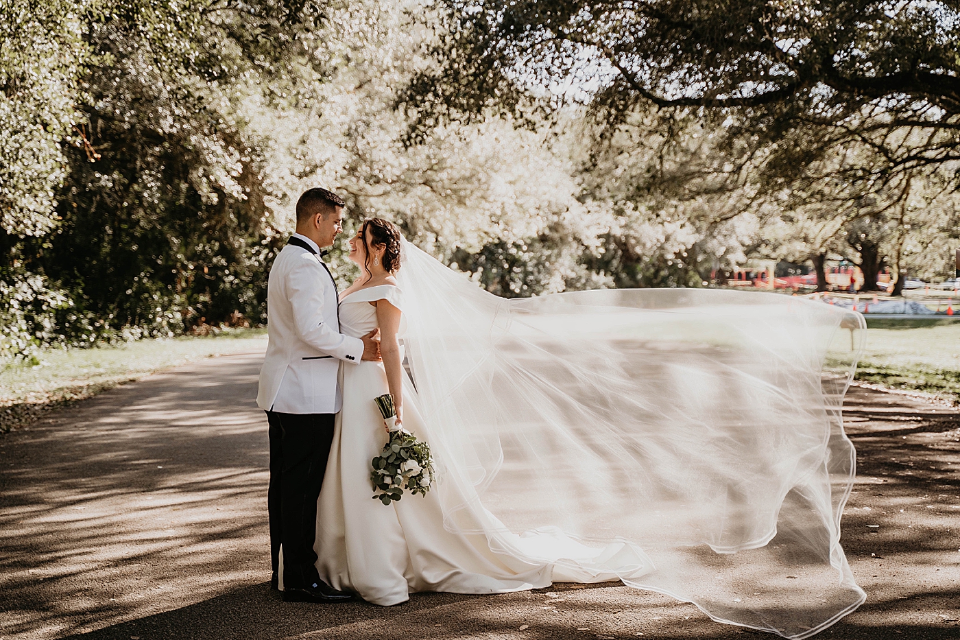 Bride and Groom holding each other with flowing veil Lavan Venue Wedding Photography captured by South Florida Wedding Photographer Krystal Capone Photography