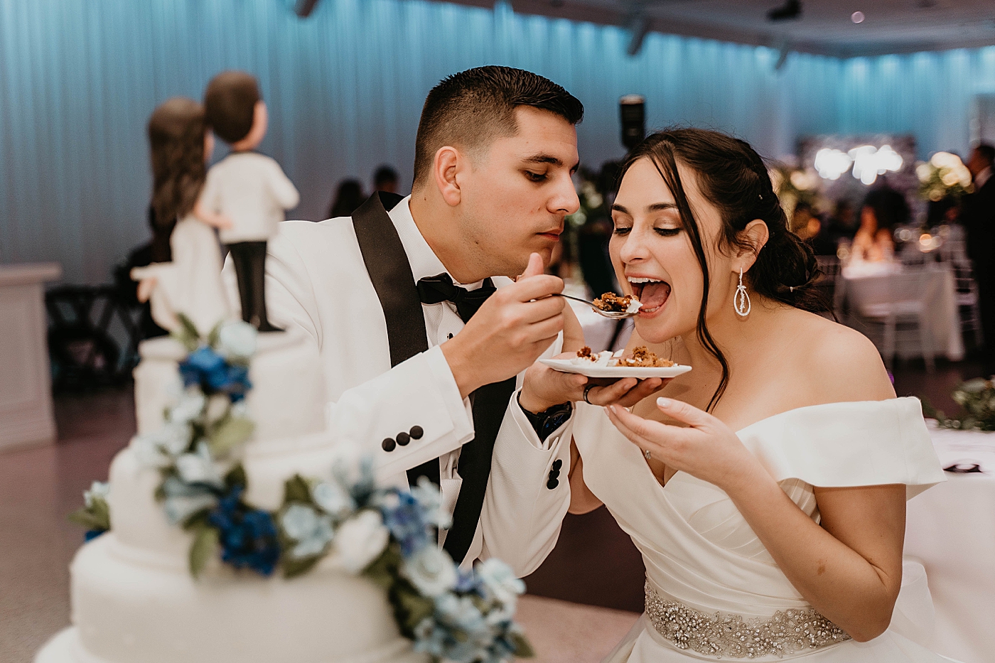 Groom giving Bride a bite of cake Lavan Venue Wedding Photography captured by South Florida Wedding Photographer Krystal Capone Photography
