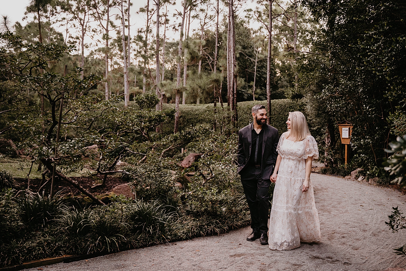 Couple strolling on the Garden path Morikami Museum and Japanese Gardens Engagement Photography captured by Krystal Capone Photography
