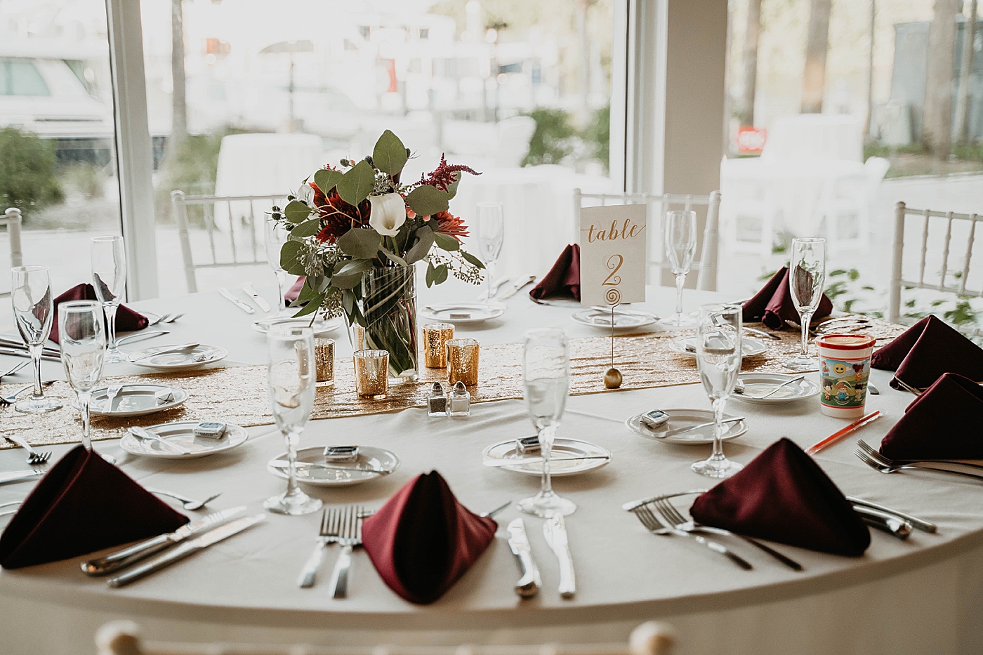 Detail Shot of Reception table with garnet napkins and flower centerpiece Out of the Blue Celebrations Wedding Photography captured by South Florida Wedding Photographer Krystal Capone Photography 